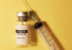 Covid-19 Impfampulle sowie eine Spritze